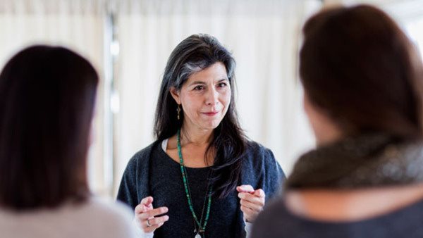 Small business owner talking to customers in store