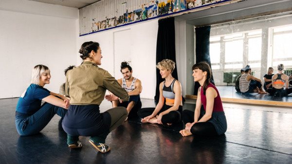 Mature female dancing teacher with her class during a break