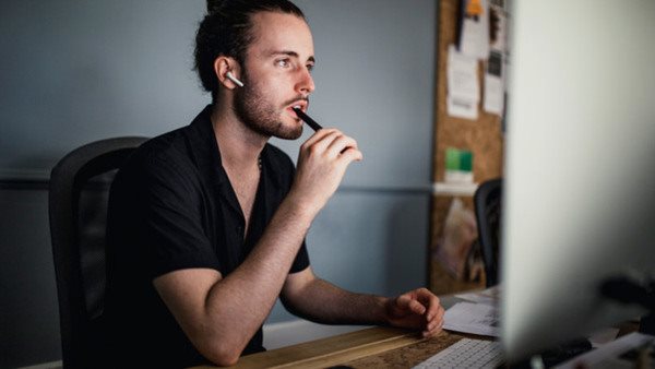 Young male working and using the computer in the office